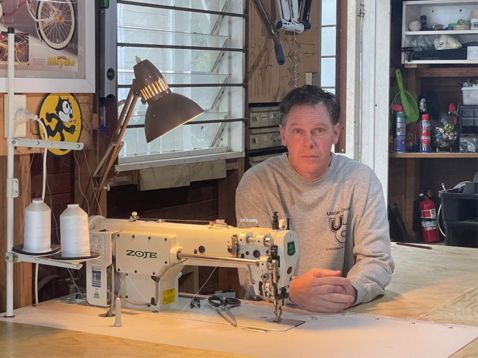 Kent working at an industrial sewing machine in the Under Cover workshop